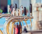 row of beer taps on a bar