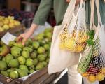 person shopping for fruit at a market stall