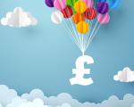 a white pound sign being held up by a string of colourful balloons