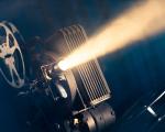 movie projector in a dark room with atmospheric smoke around it