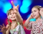 Two young girls enjoying a 3D experience surrounded by blue lights