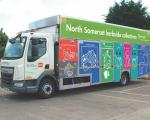 Recycling truck with brightly coloured livery in a car park