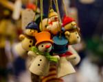 a bunch of small wooden snowman decorations on string