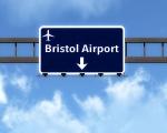 blue road sign with a direction arrow for Bristol airport