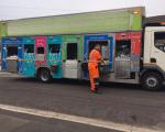 bin man sorting recycling next to a recycling truck