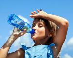 young girl drinking from a bottle of water