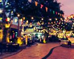 a courtyard with bunting and fairy lights strung above