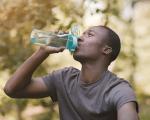 man drinking from a bottle of water