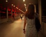 woman walking through a tunnel at night