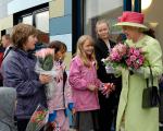Her Majesty Queen Elizabeth the second talks with a group of children outside of Ashcombe Children's Centre