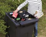 Person putting rubbish in new Quatro recycling bin
