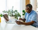 An older man looking at a computer