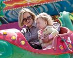 a mother and daughter on a fairground ride