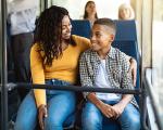 Mother and son sitting on a bus