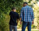 adult man and young boy walking