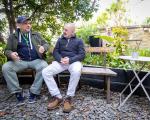 Two older men talking on a bench