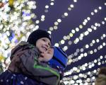 Two boys under sparkly Christmas lights