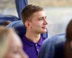 A young man sitting on a bus