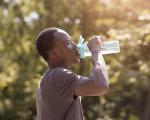 a person drinking water in the heat