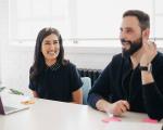 man and woman talking in a meeting