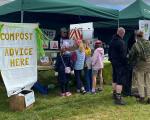 children reading leaflets at a compost stand