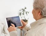 This shows an elderly woman using care technology