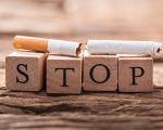 broken cigarette on top of letter blocks that spell 'stop'