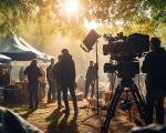 filming crew with sunlight breaking through trees