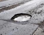 This shows a pothole in the road