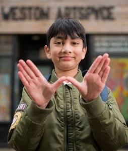boy making a 'W' with his hands
