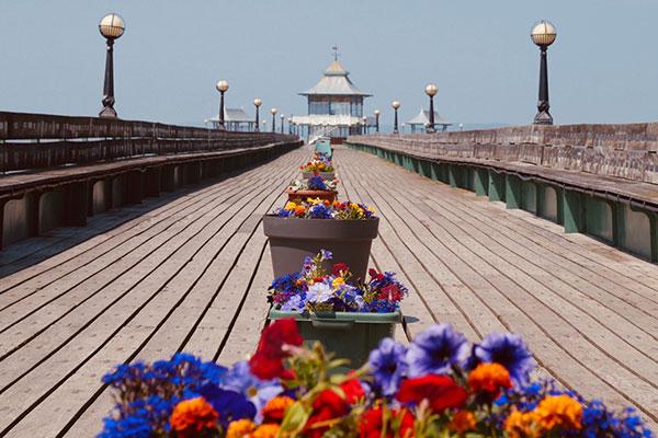 Clevedon Pier with colourful flowers on the walkway