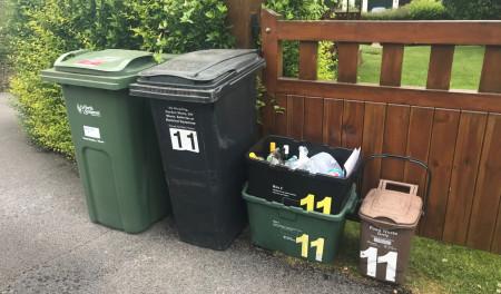 North Somerset Council waste and recycling bins lined up against a wall