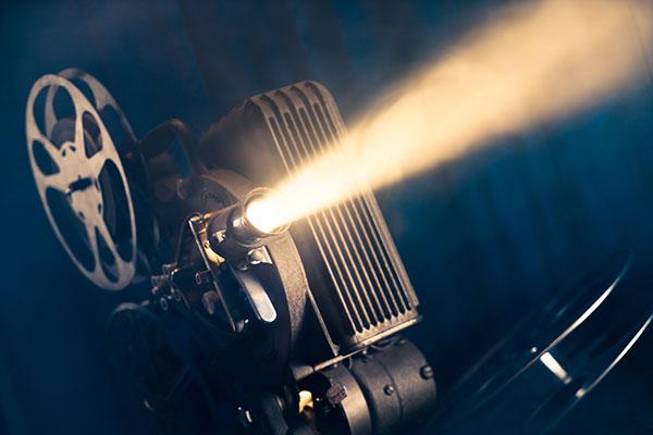 movie projector in a dark room with atmospheric smoke around it