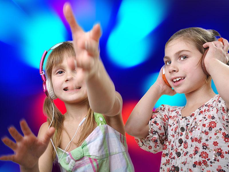 Two young girls enjoying a 3D experience surrounded by blue lights