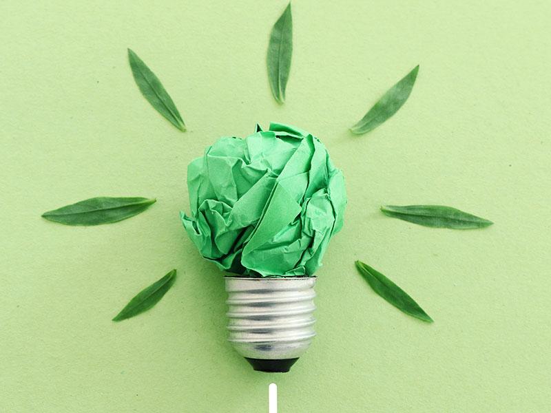 lightbulb made of screwed up green paper