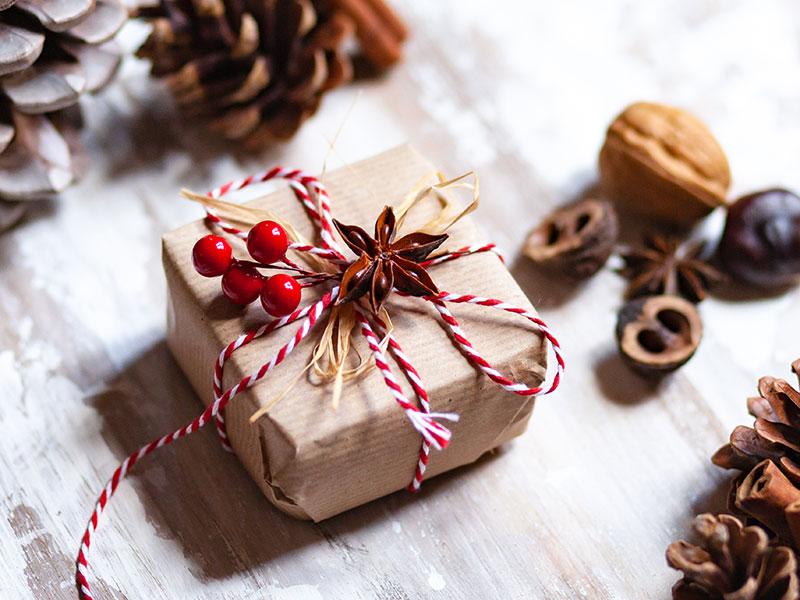 Christmas gift wrapped in brown paper and red ribbon