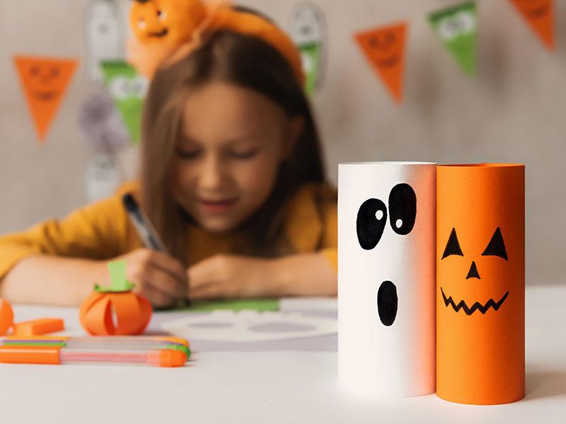 Young girl making Halloween crafts