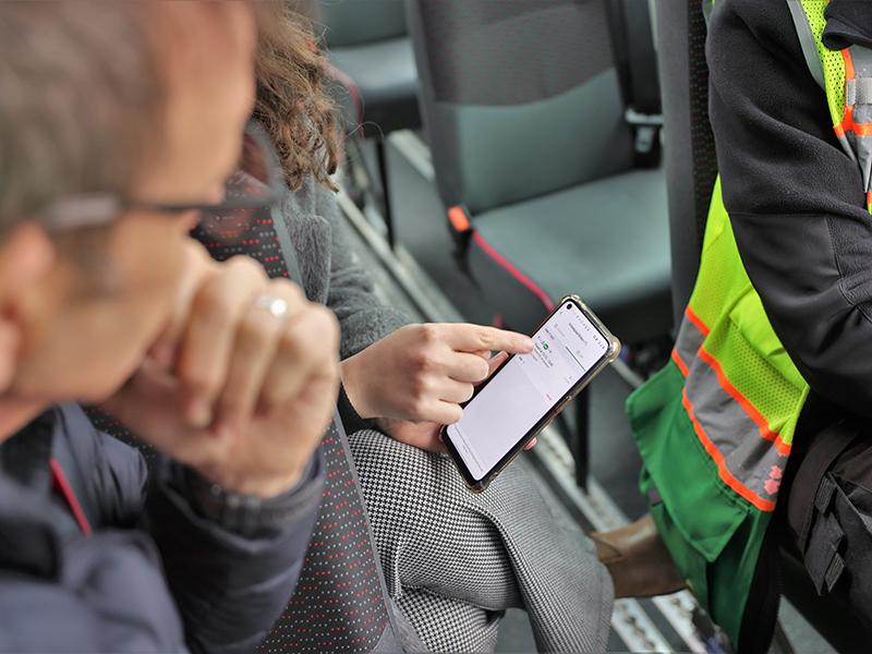 People using a mobile app to book buses