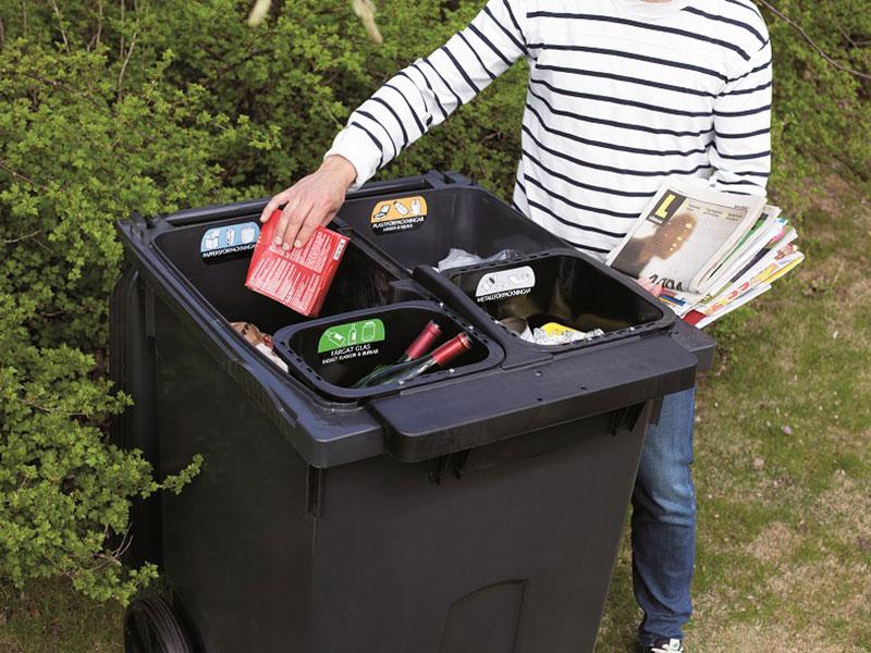 Person putting rubbish in new Quatro recycling bin