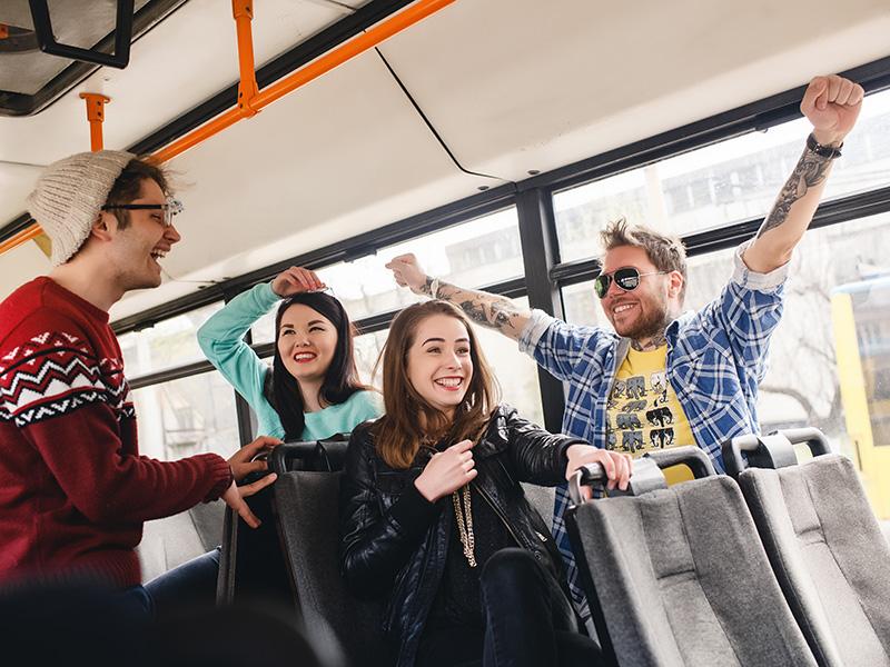 Happy young people on a bus
