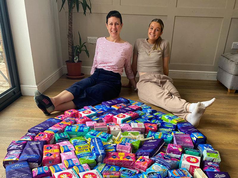 Two women with period products