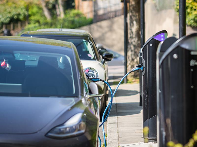 EV cars getting charged on the street
