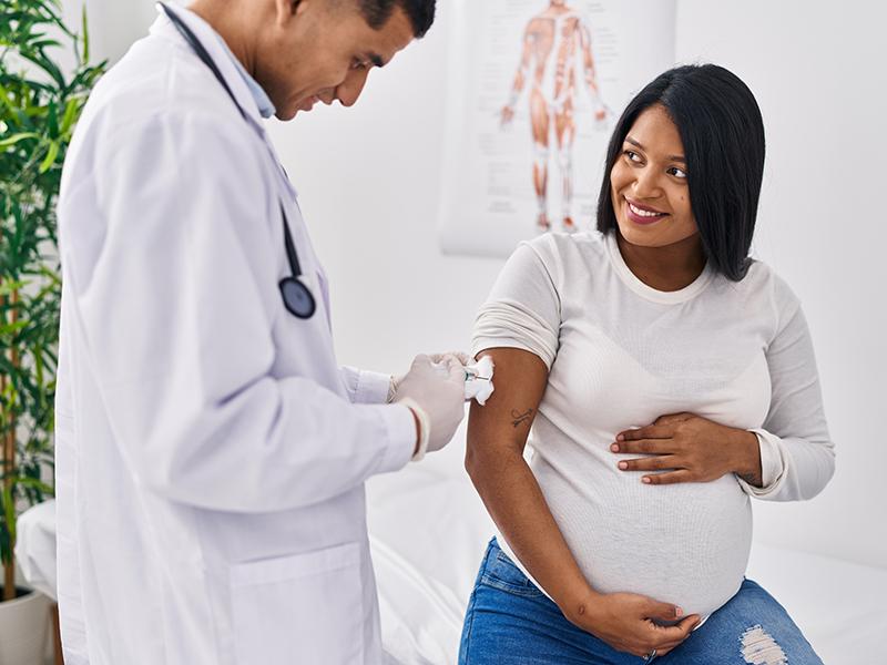 a pregnant woman getting a vaccine