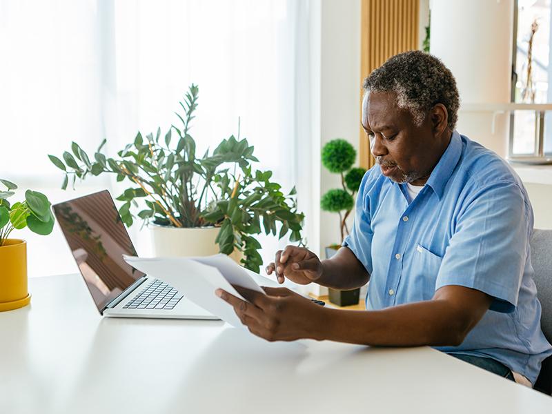 An older man looking at a computer