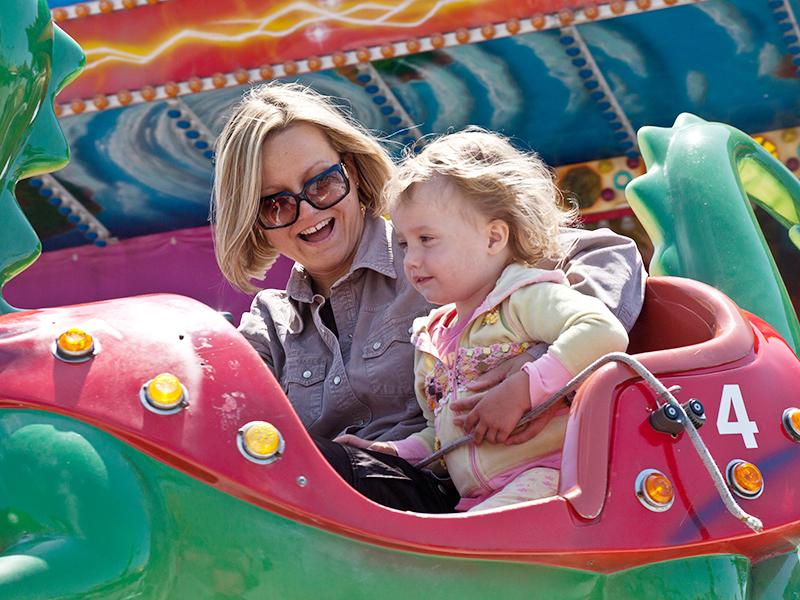 a mother and daughter on a fairground ride