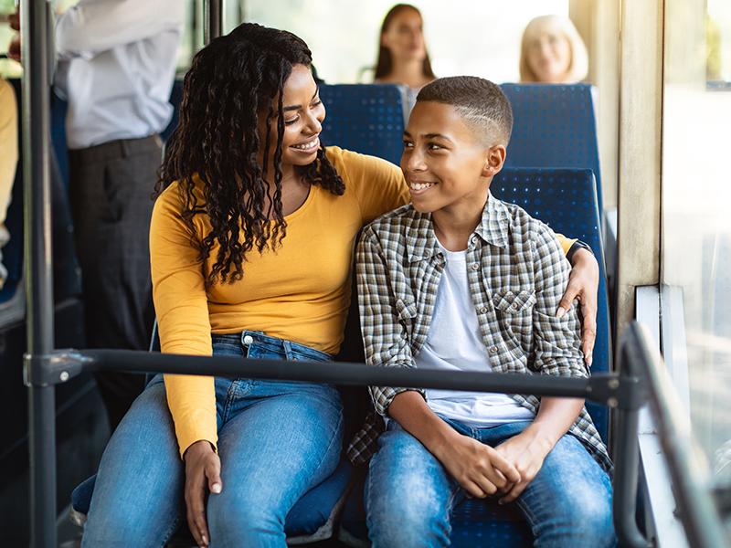 Mother and son sitting on a bus