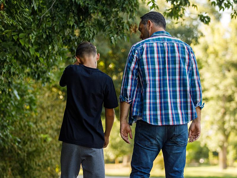 adult man and young boy walking