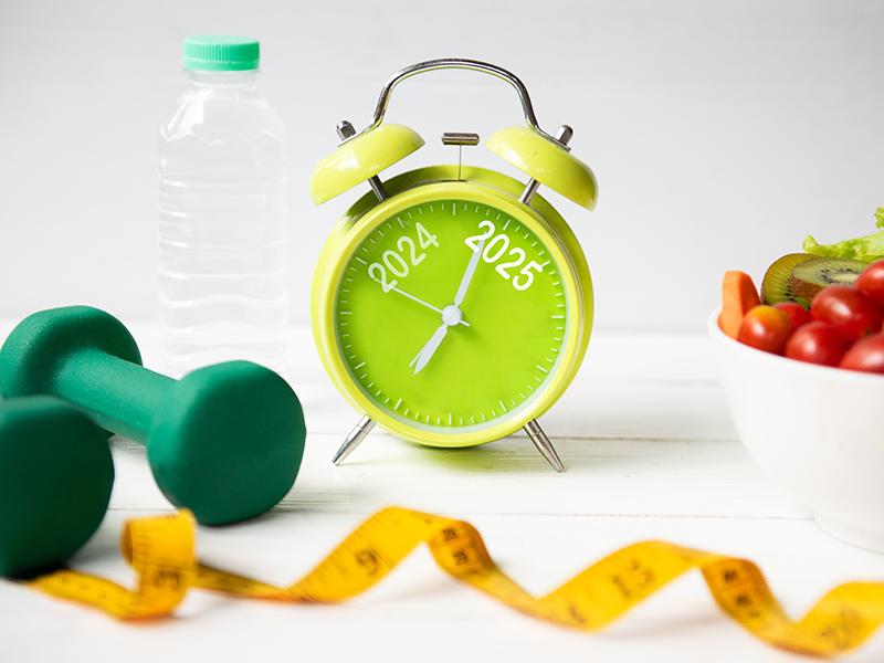 Alarm clock with '2025' written on it surrounded by health accessories 