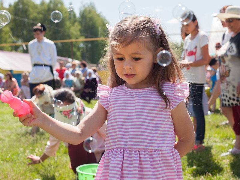 young girl playing with bubbles