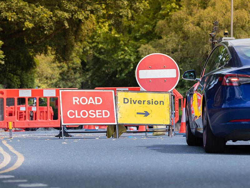 This image shows a picture of a road being closed
